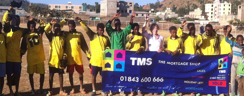 A fantastic picture of some happy boys in Ethiopia wearing a football kit that the Mortgage Shop donated